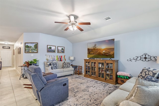 living room with light tile patterned floors, ceiling fan, visible vents, and vaulted ceiling