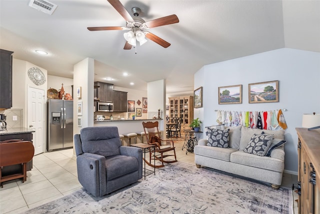 living area with lofted ceiling, ceiling fan, light tile patterned flooring, recessed lighting, and visible vents