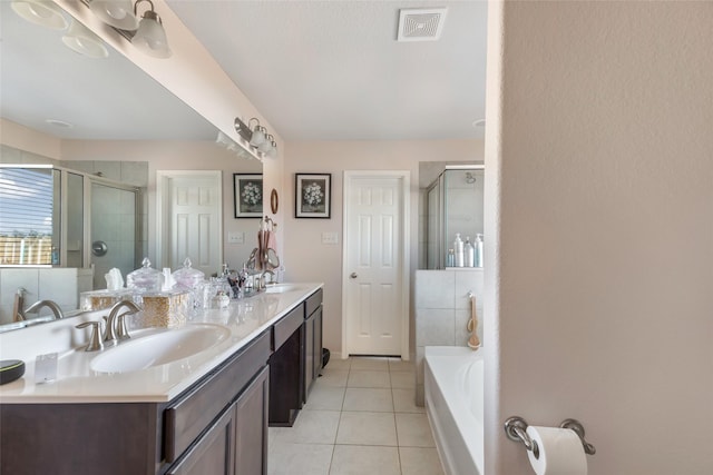 bathroom featuring tile patterned flooring, a washtub, a sink, visible vents, and a shower stall