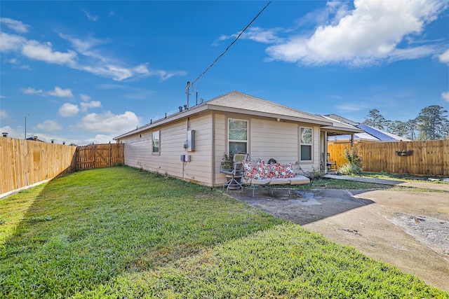 back of house with a patio, a lawn, and a fenced backyard