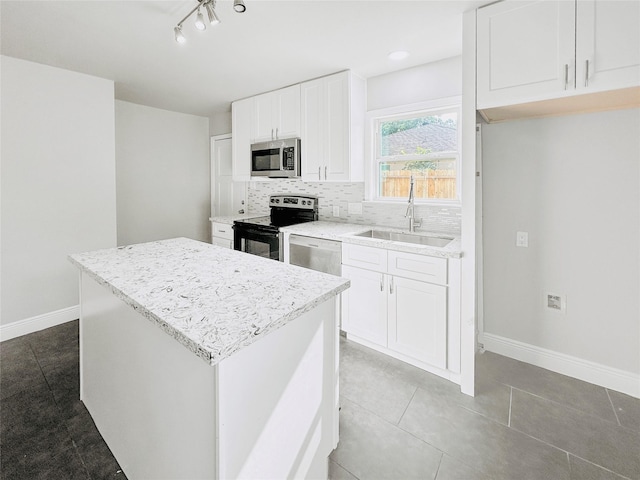 kitchen featuring white dishwasher, electric range, a sink, decorative backsplash, and stainless steel microwave