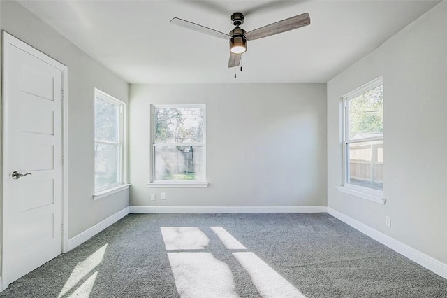 unfurnished room featuring carpet, baseboards, and a ceiling fan