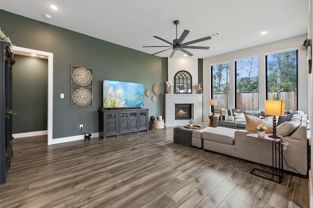 unfurnished living room with ceiling fan, baseboards, recessed lighting, a fireplace, and wood finished floors