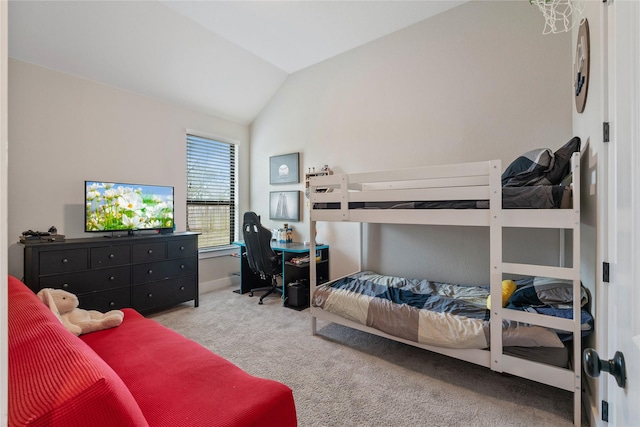 bedroom featuring baseboards, lofted ceiling, and carpet