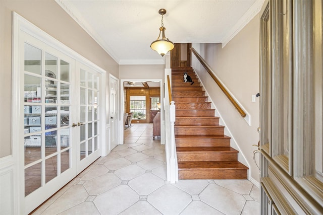 interior space with french doors, crown molding, light tile patterned floors, stairway, and baseboards