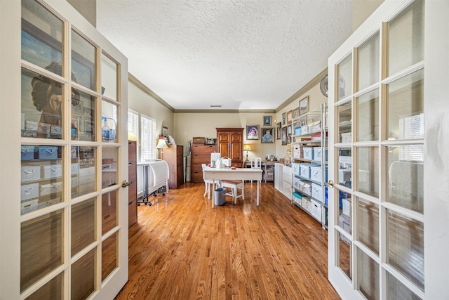 office area featuring ornamental molding, french doors, a textured ceiling, and wood finished floors