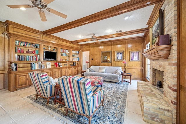 living area featuring light tile patterned floors, visible vents, a brick fireplace, wooden walls, and beamed ceiling