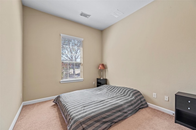 bedroom with carpet, visible vents, and baseboards