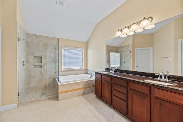 bathroom with vaulted ceiling, a garden tub, a sink, and visible vents