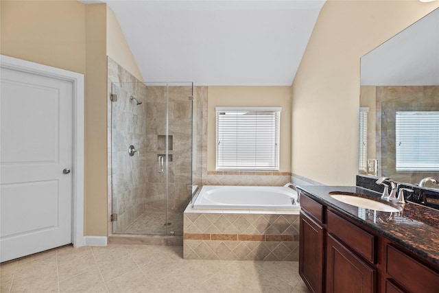 full bath featuring a stall shower, tile patterned flooring, vaulted ceiling, and a bath