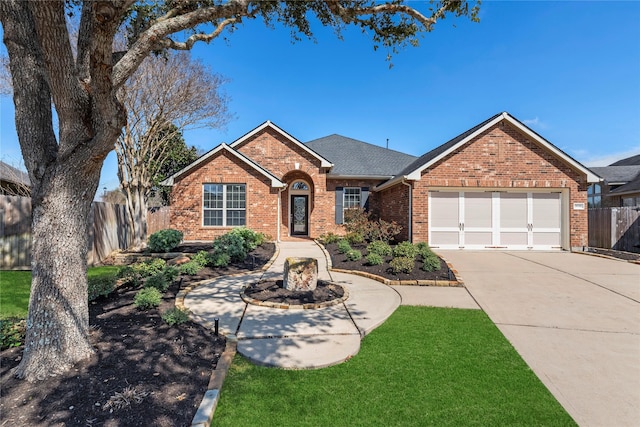 single story home with a garage, concrete driveway, roof with shingles, fence, and brick siding