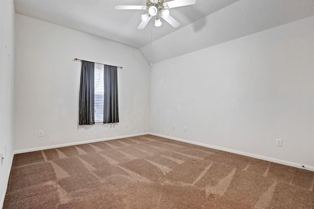 empty room with carpet, baseboards, vaulted ceiling, and a ceiling fan