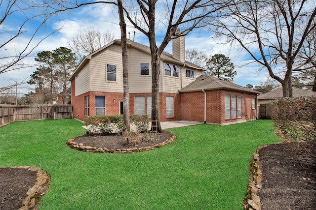 view of property exterior featuring a lawn, a fenced backyard, a chimney, a patio area, and brick siding