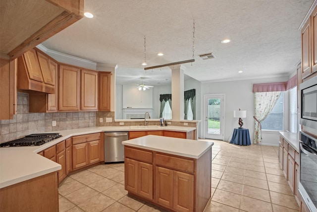 kitchen featuring tasteful backsplash, visible vents, appliances with stainless steel finishes, light countertops, and a sink