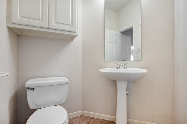 bathroom featuring toilet, visible vents, baseboards, and tile patterned floors