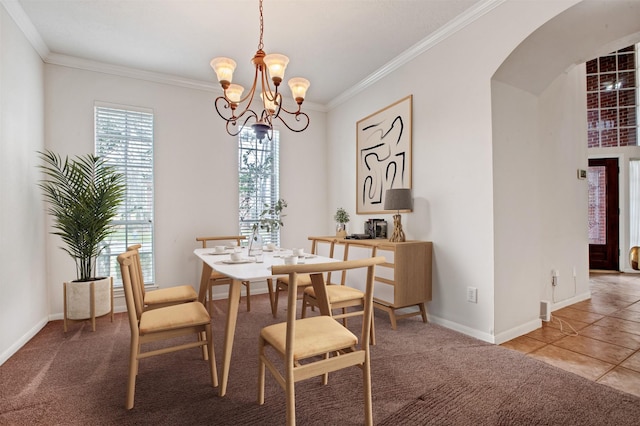 dining room featuring arched walkways, crown molding, carpet, and an inviting chandelier