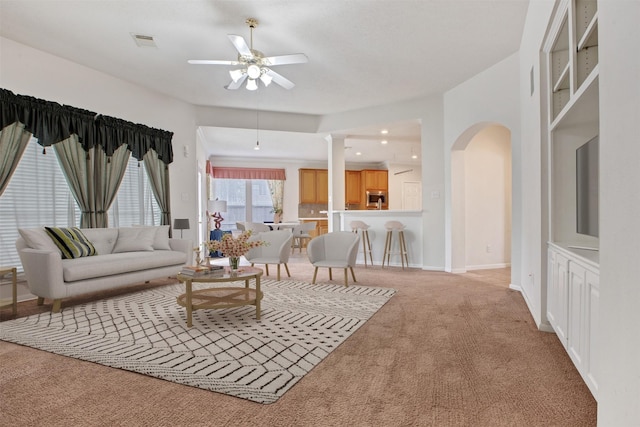 living room featuring ceiling fan, recessed lighting, light colored carpet, visible vents, and baseboards