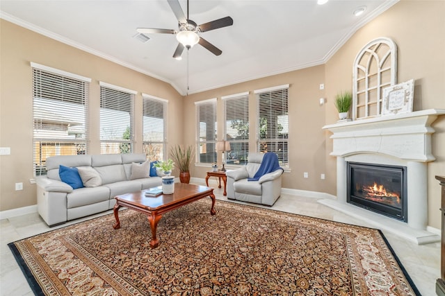 living area featuring ornamental molding, a glass covered fireplace, and tile patterned flooring