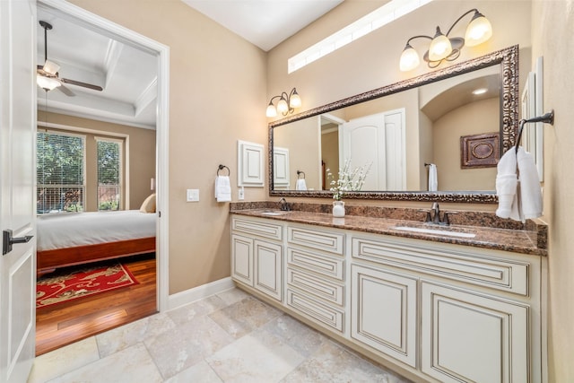 bathroom featuring double vanity, a ceiling fan, baseboards, and a sink