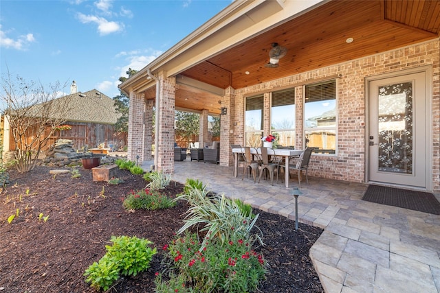 view of patio featuring outdoor dining space and fence