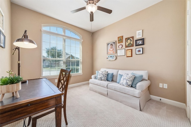 carpeted office featuring a ceiling fan and baseboards