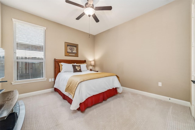 bedroom with a ceiling fan, carpet flooring, and baseboards