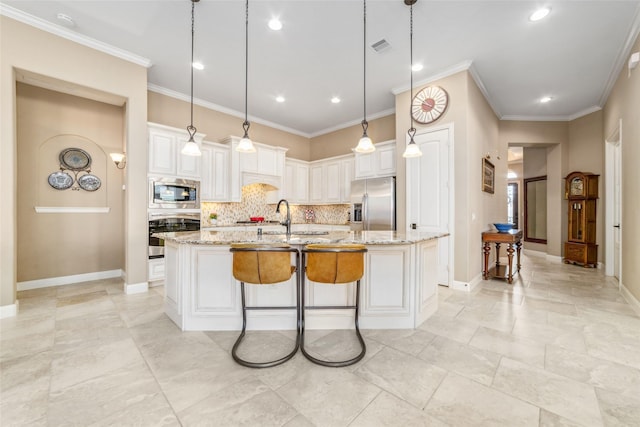 kitchen with appliances with stainless steel finishes, backsplash, light stone counters, and white cabinetry