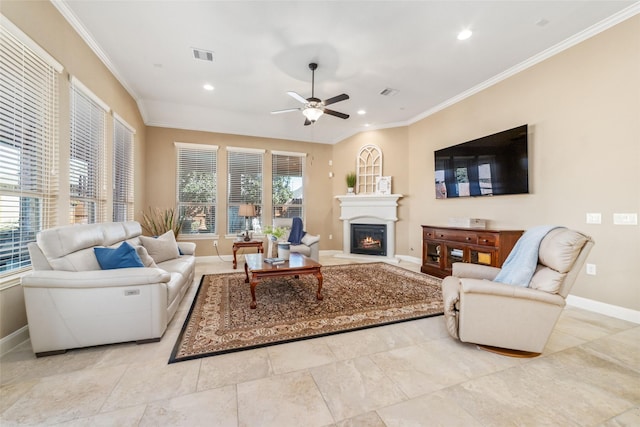 living room featuring recessed lighting, crown molding, a lit fireplace, and baseboards