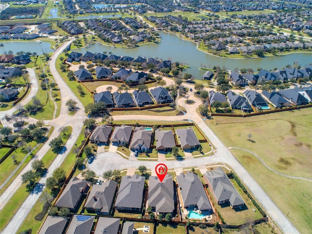 drone / aerial view with a water view and a residential view