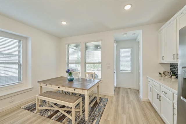 dining room featuring light wood-style floors, a wealth of natural light, and recessed lighting