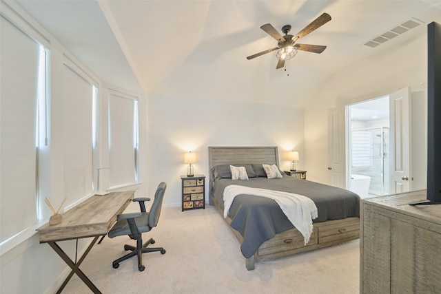 bedroom with ceiling fan, connected bathroom, light colored carpet, visible vents, and vaulted ceiling