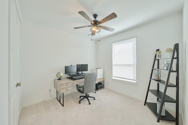 office space with carpet flooring, a ceiling fan, and baseboards