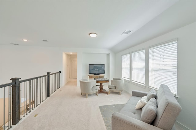 living room featuring baseboards, visible vents, and light colored carpet