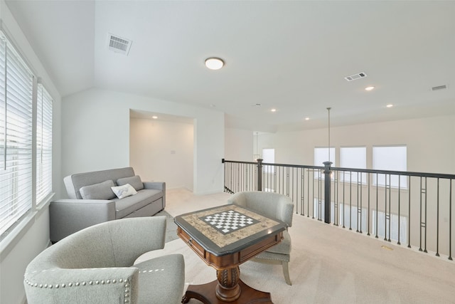 carpeted living room with lofted ceiling, visible vents, and recessed lighting