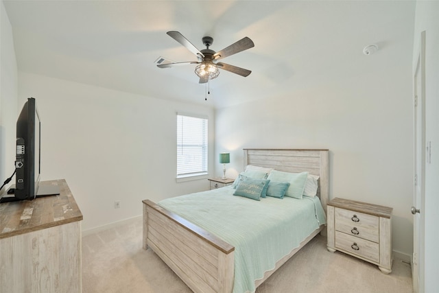 bedroom with a ceiling fan, light colored carpet, and baseboards