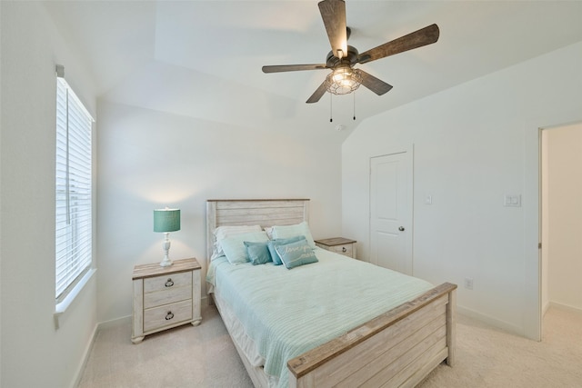 bedroom with a ceiling fan, light colored carpet, and baseboards