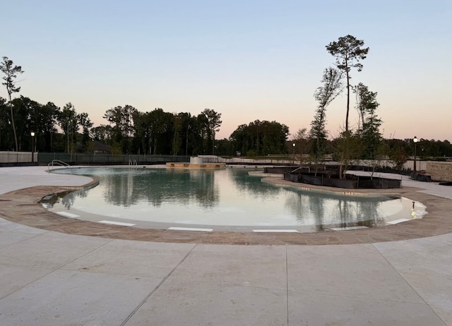 21500 Jordan Pond Rdg, Porter, TX 77365 - pool at dusk with a community pool, fence, and a patio area