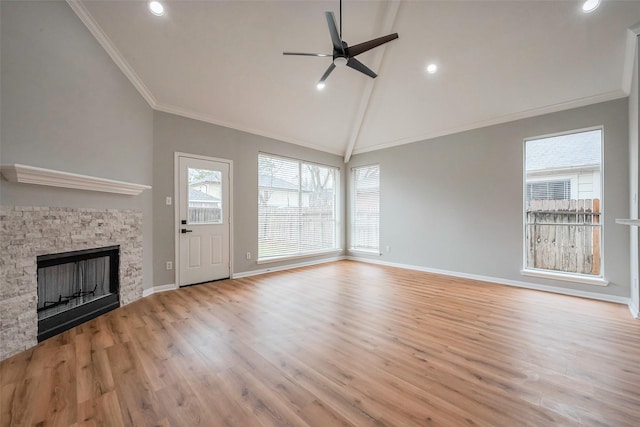 unfurnished living room featuring ornamental molding, a stone fireplace, baseboards, and wood finished floors