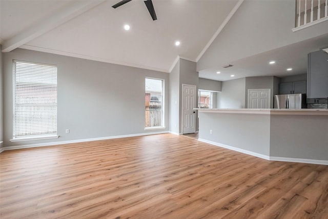 unfurnished living room featuring light wood-style floors, baseboards, and crown molding