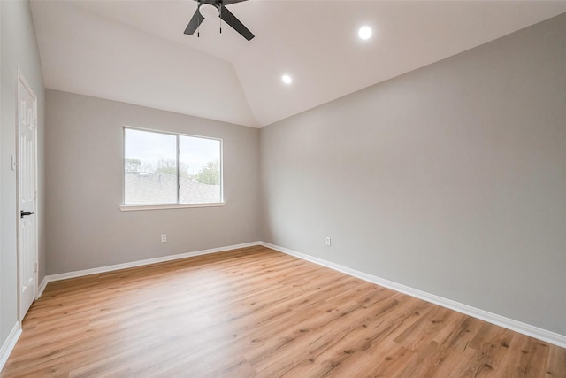 empty room featuring vaulted ceiling, ceiling fan, light wood finished floors, and baseboards