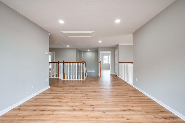 unfurnished room featuring recessed lighting, baseboards, and light wood finished floors