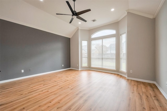 empty room featuring baseboards, a ceiling fan, lofted ceiling, light wood-style flooring, and ornamental molding