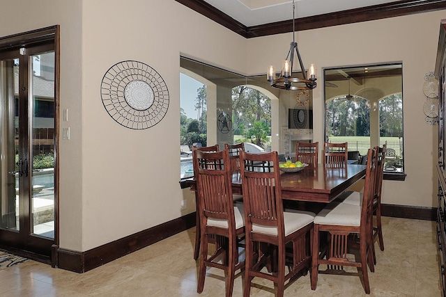 dining area with baseboards, arched walkways, ornamental molding, french doors, and a notable chandelier