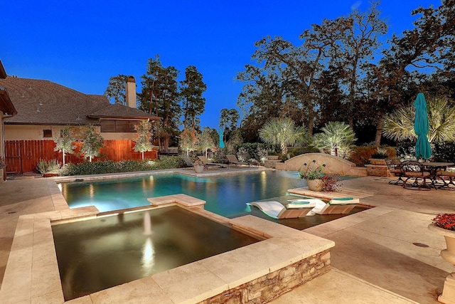 view of swimming pool featuring a fenced in pool, a patio, fence, and an in ground hot tub