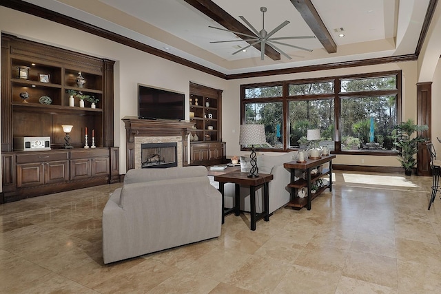 living room with baseboards, ceiling fan, built in shelves, a fireplace, and beam ceiling