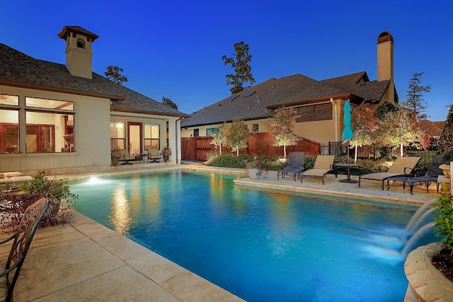 view of swimming pool featuring a fenced in pool, a patio area, and fence