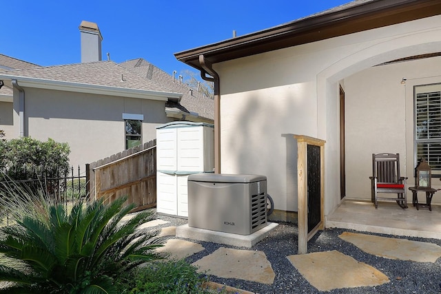 view of patio / terrace with fence and an outdoor structure