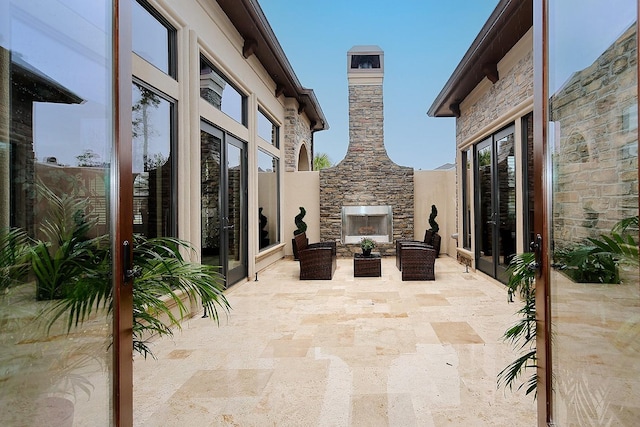 view of patio featuring an outdoor stone fireplace