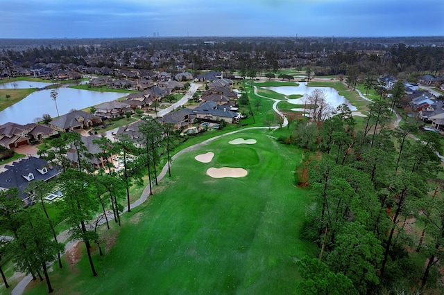 aerial view with view of golf course, a water view, and a residential view