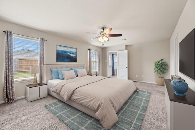 bedroom with carpet floors, visible vents, baseboards, and a ceiling fan